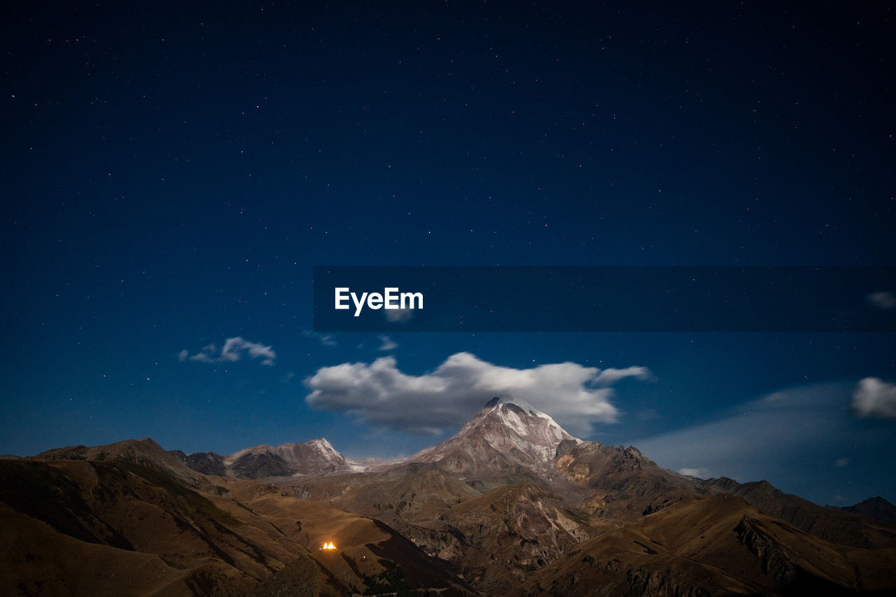 SCENIC VIEW OF MOUNTAIN RANGE AGAINST SKY AT NIGHT