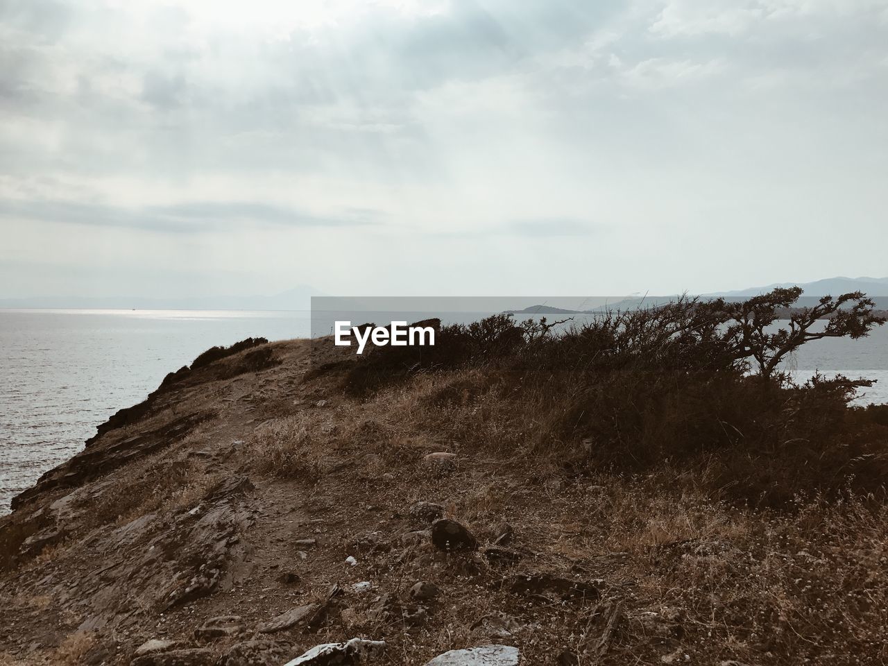 Scenic view of sea and mountains against sky