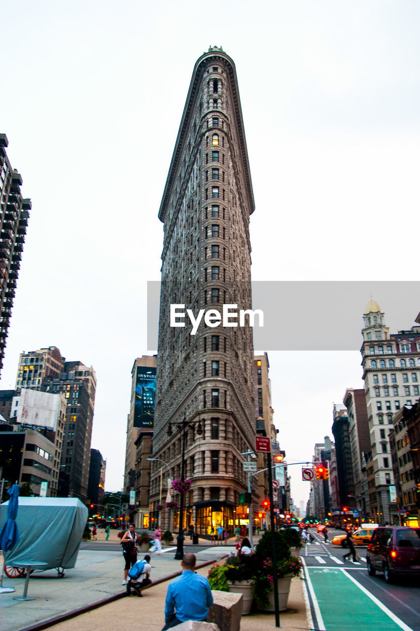 Low angle view of flatiron building against sky in city