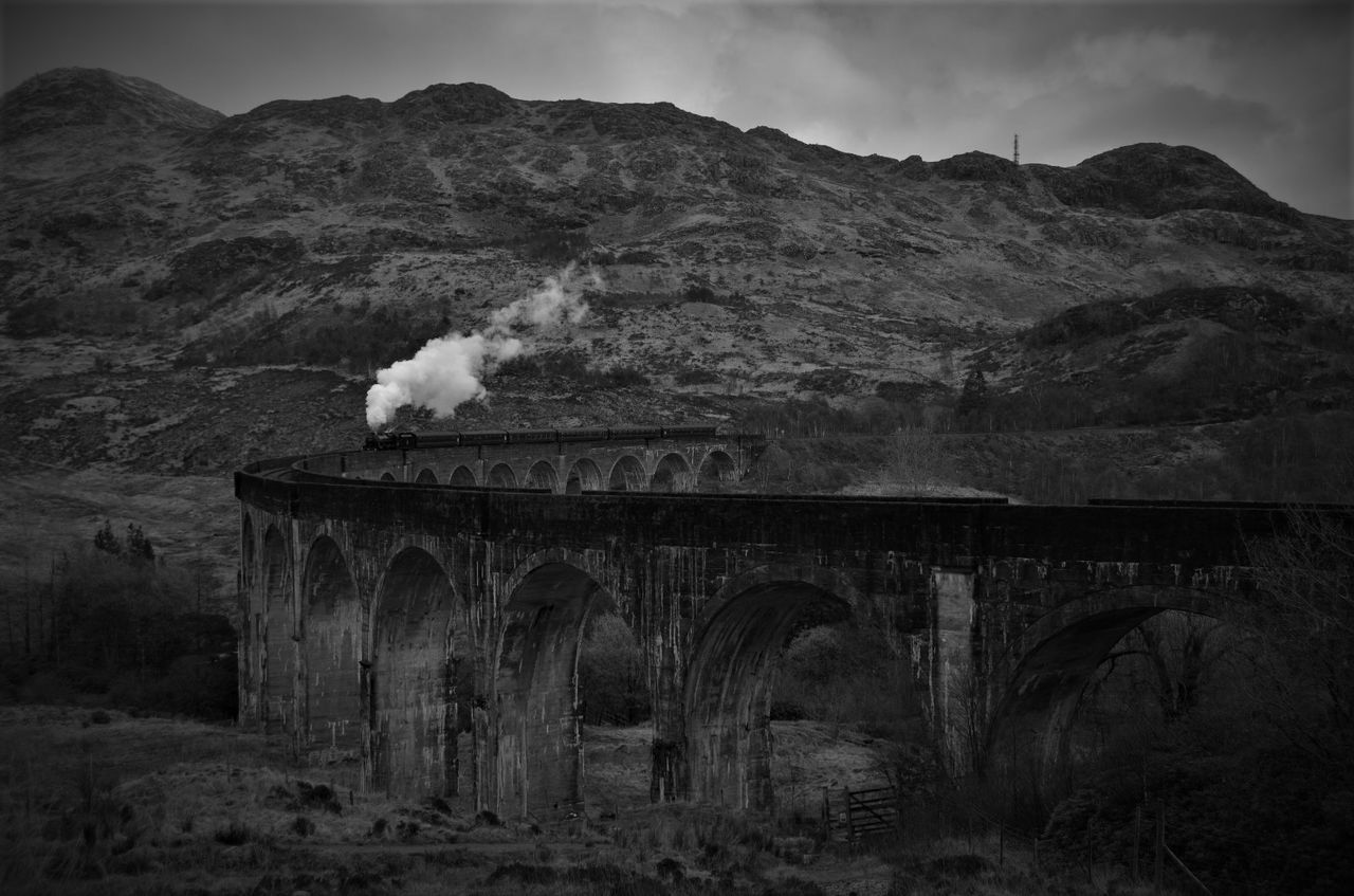 Scenic view of railroad track against mountain