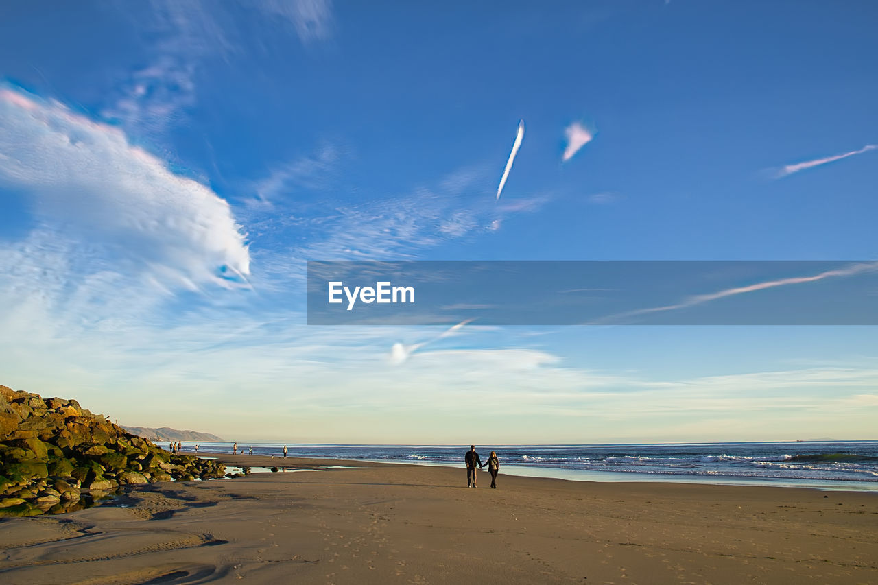 sky, land, beach, sea, water, horizon, cloud, body of water, nature, sand, ocean, scenics - nature, beauty in nature, coast, shore, horizon over water, blue, holiday, travel destinations, tranquility, environment, vacation, trip, sunlight, travel, tranquil scene, wave, landscape, coastline, outdoors, dusk, tourism, water's edge, motion, summer, leisure activity, day, non-urban scene, idyllic, seascape, sunset