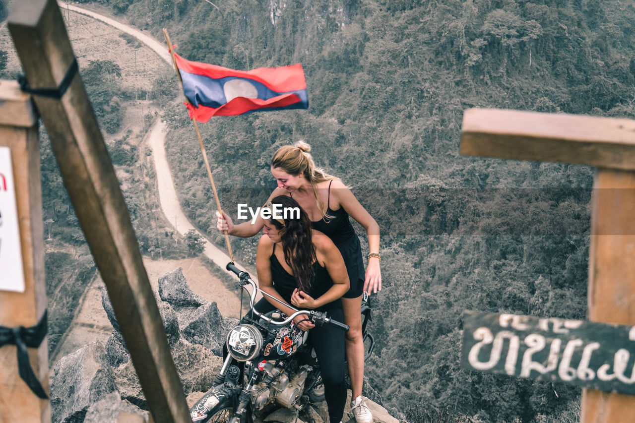 HIGH ANGLE VIEW OF WOMAN WITH UMBRELLA AT BUS