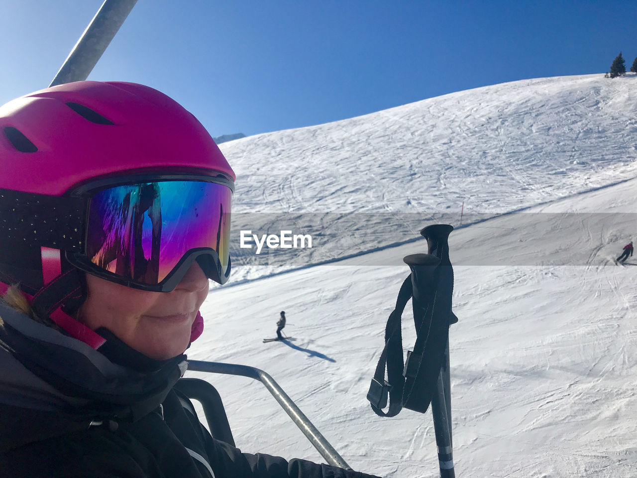 Woman with skiing poles on snowcapped mountain