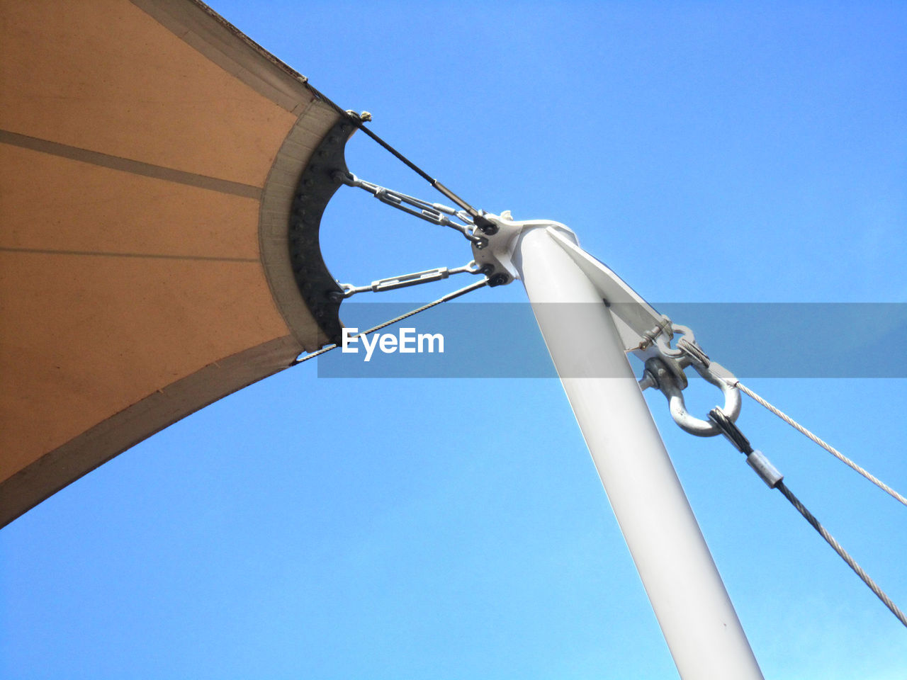 LOW ANGLE VIEW OF TELEPHONE POLE AGAINST CLEAR SKY