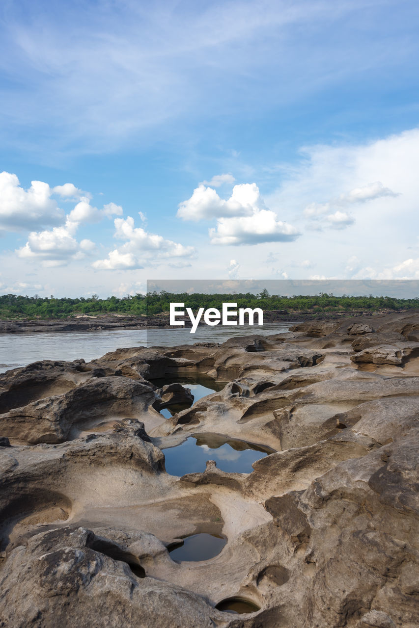 ROCKS ON LAND AGAINST SKY