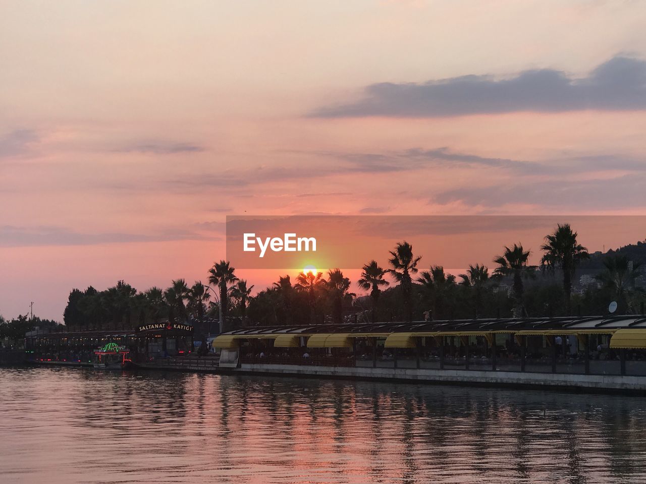 SCENIC VIEW OF RIVER BY TREES AGAINST SKY DURING SUNSET