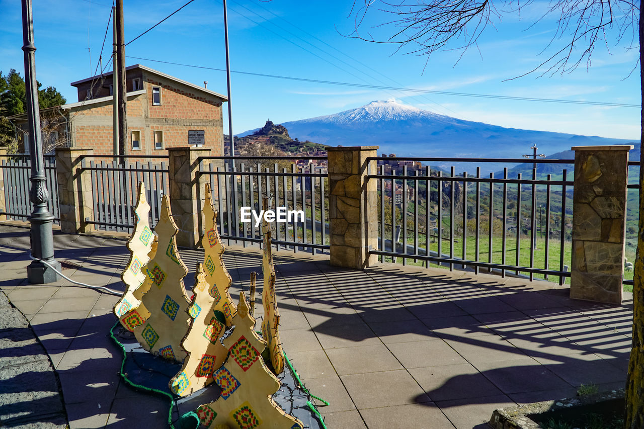 architecture, nature, sky, mountain, built structure, no people, building exterior, day, building, sunlight, outdoors, fence, travel destinations, city, gate, tree, water, shadow, plant