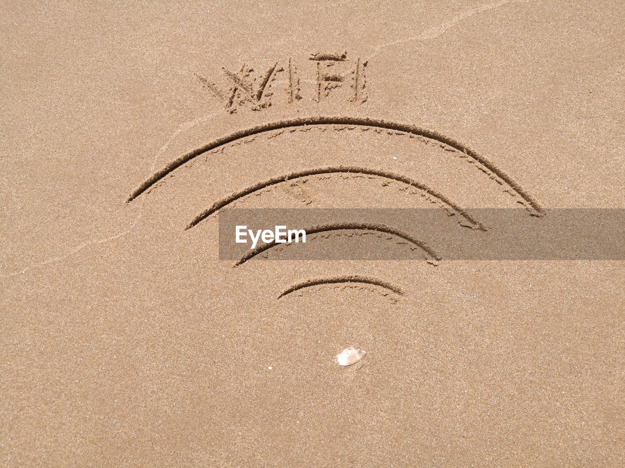 High angle view of wi-fi sign on sand at beach