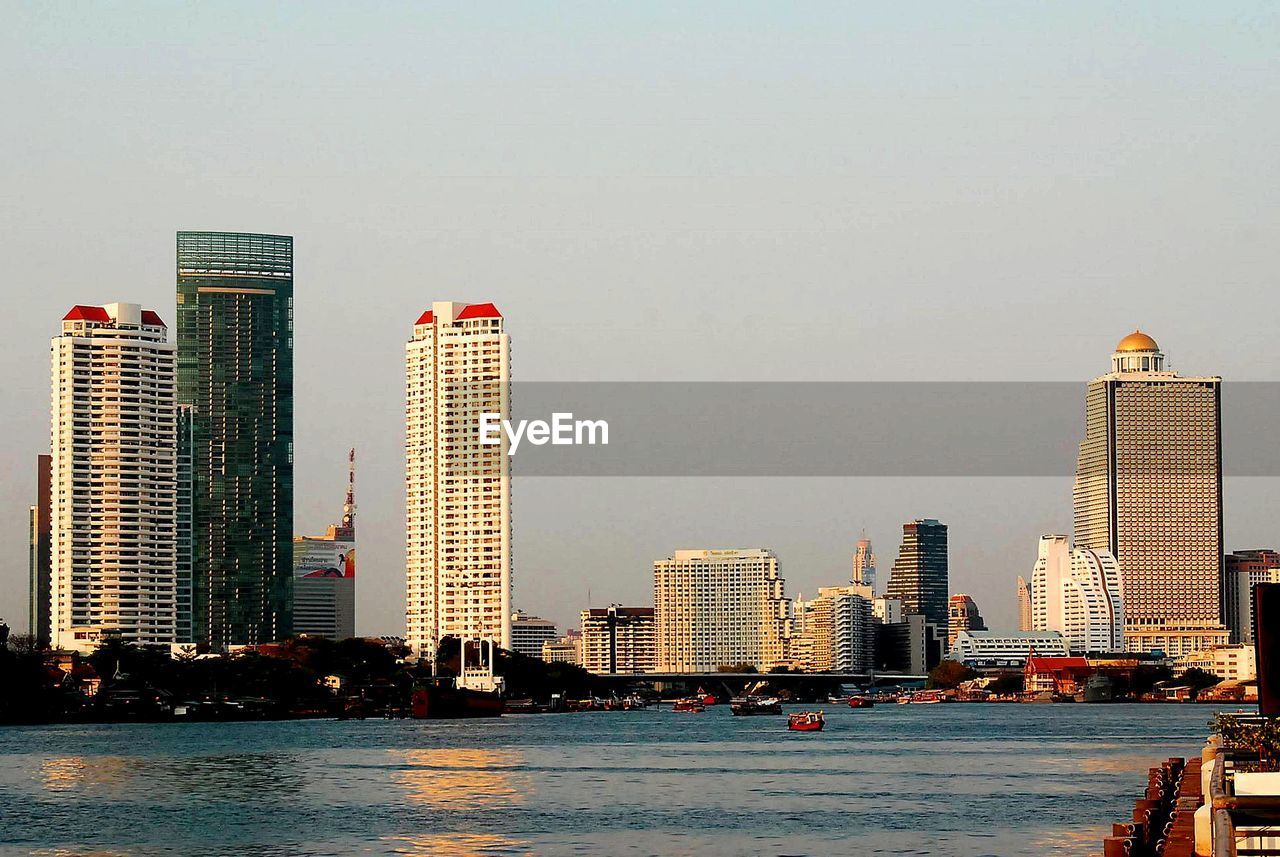 MODERN BUILDINGS BY SEA AGAINST SKY