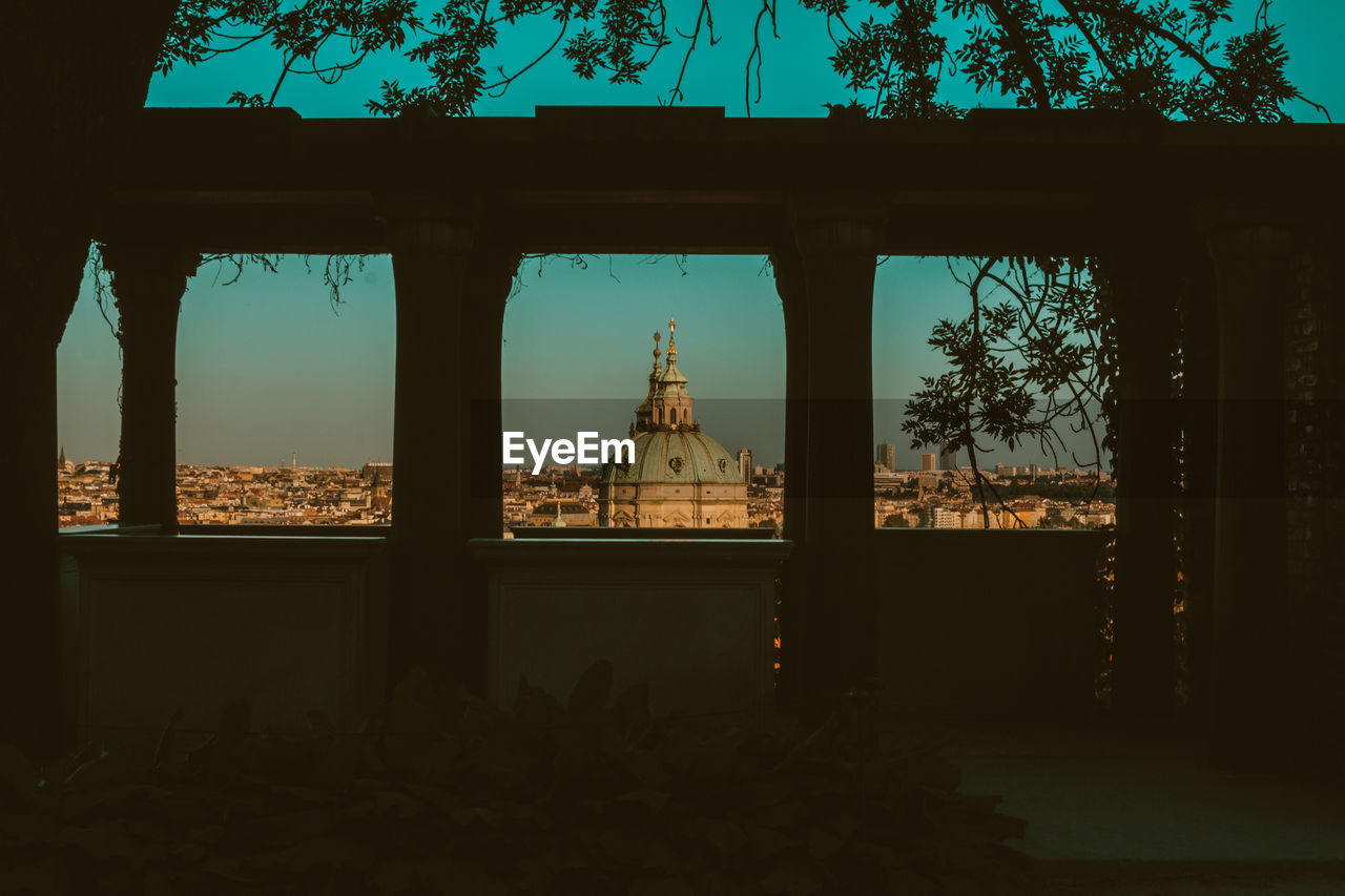 VIEW OF HISTORIC BUILDING SEEN THROUGH WINDOW