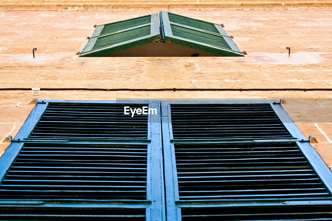 Low angle view of shutter windows on building