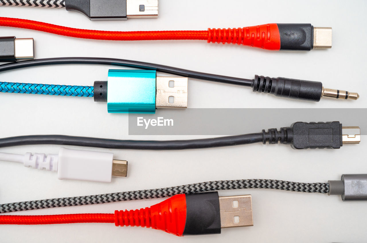 cable, technology, electrical wiring, electricity, electrical connector, electric plug, internet, computer cable, computer network, power supply, communication, wireless technology, equipment, power line, network connection plug, computer, electrical supply, power generation, no people, indoors, studio shot, wire, close-up, work tool, usb cable, red