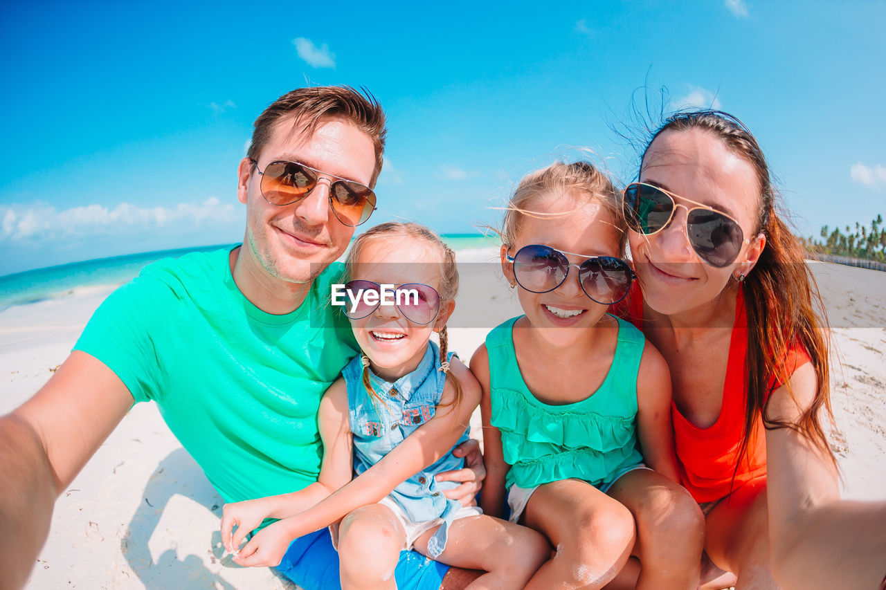 Portrait of family sitting on beach