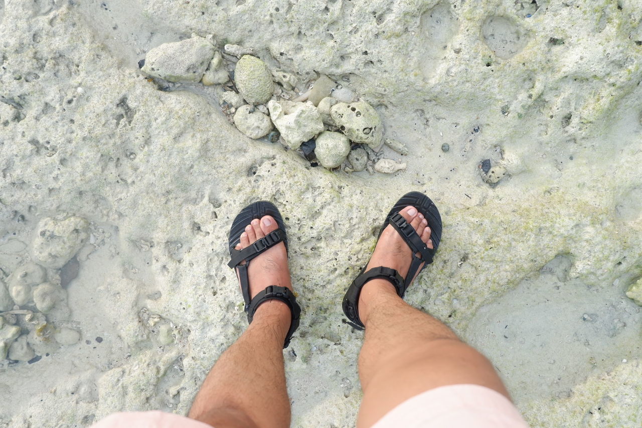 LOW SECTION OF PERSON STANDING ON ROCKS