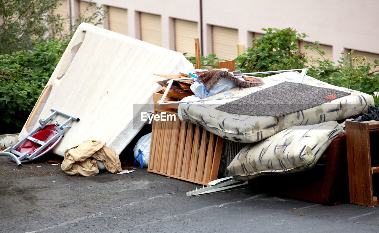 Broken furniture and sleeping goods ready to be thrown away and picked up.