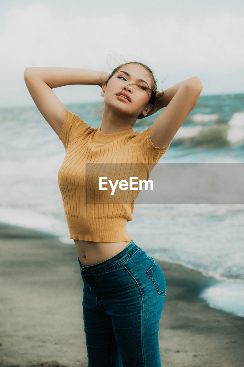 Young woman standing at beach