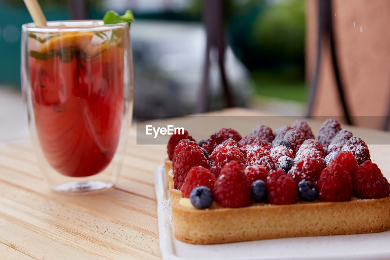 Sugar free french tart with raspberry and blueberry at the terrace. refreshing raspberry lemonade