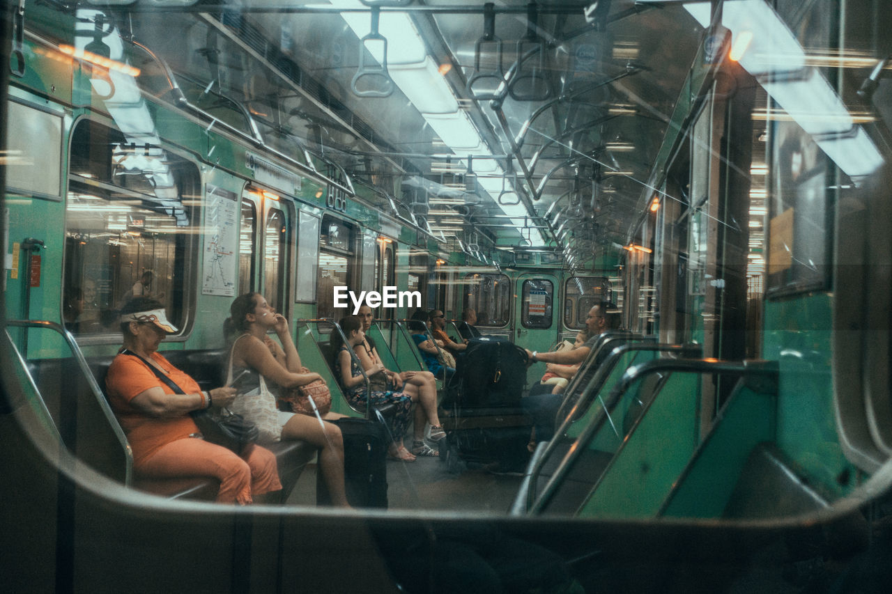 PEOPLE SITTING IN TRAIN