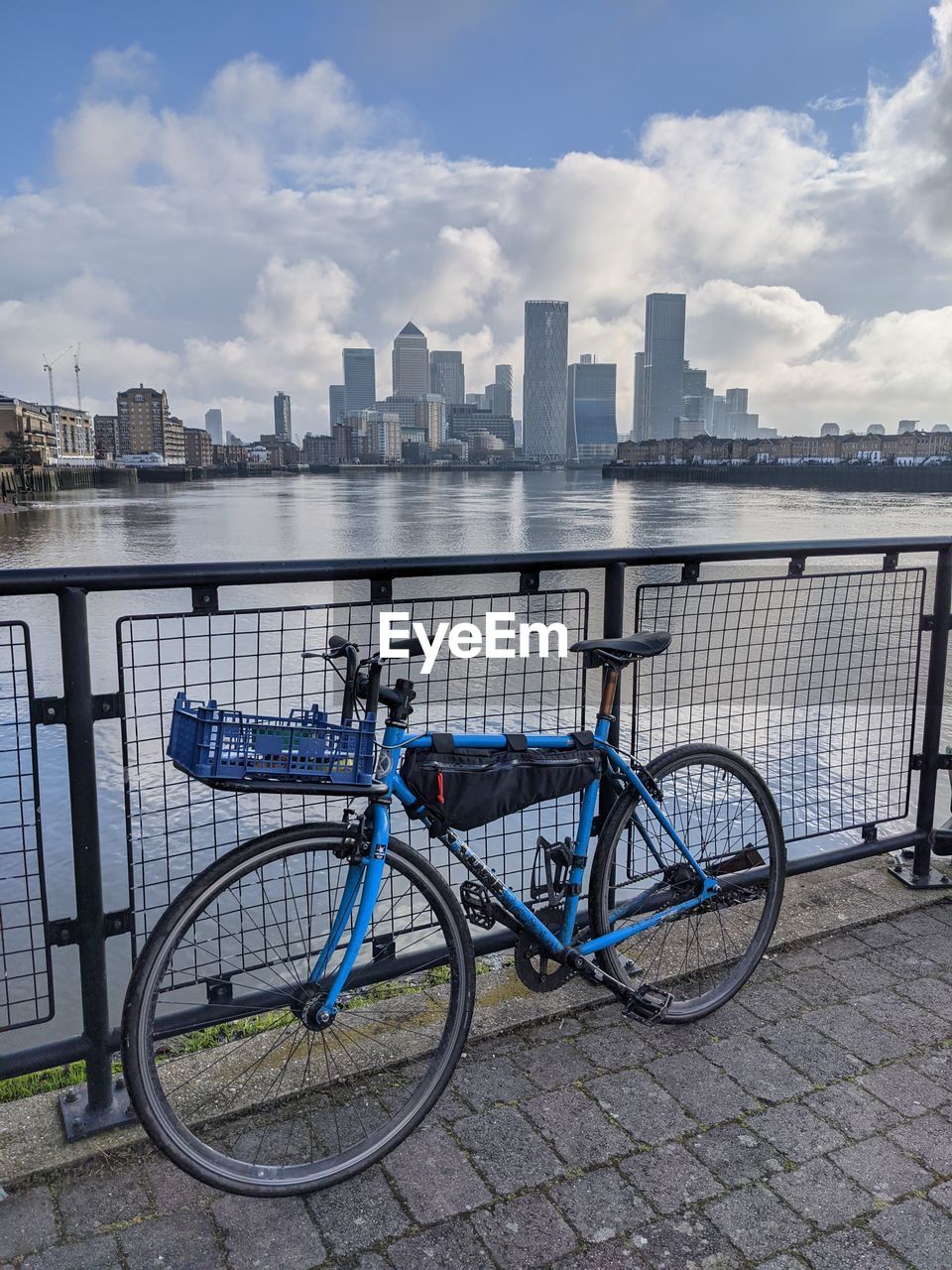 Bicycle in front of the thames river and canary wharf in london