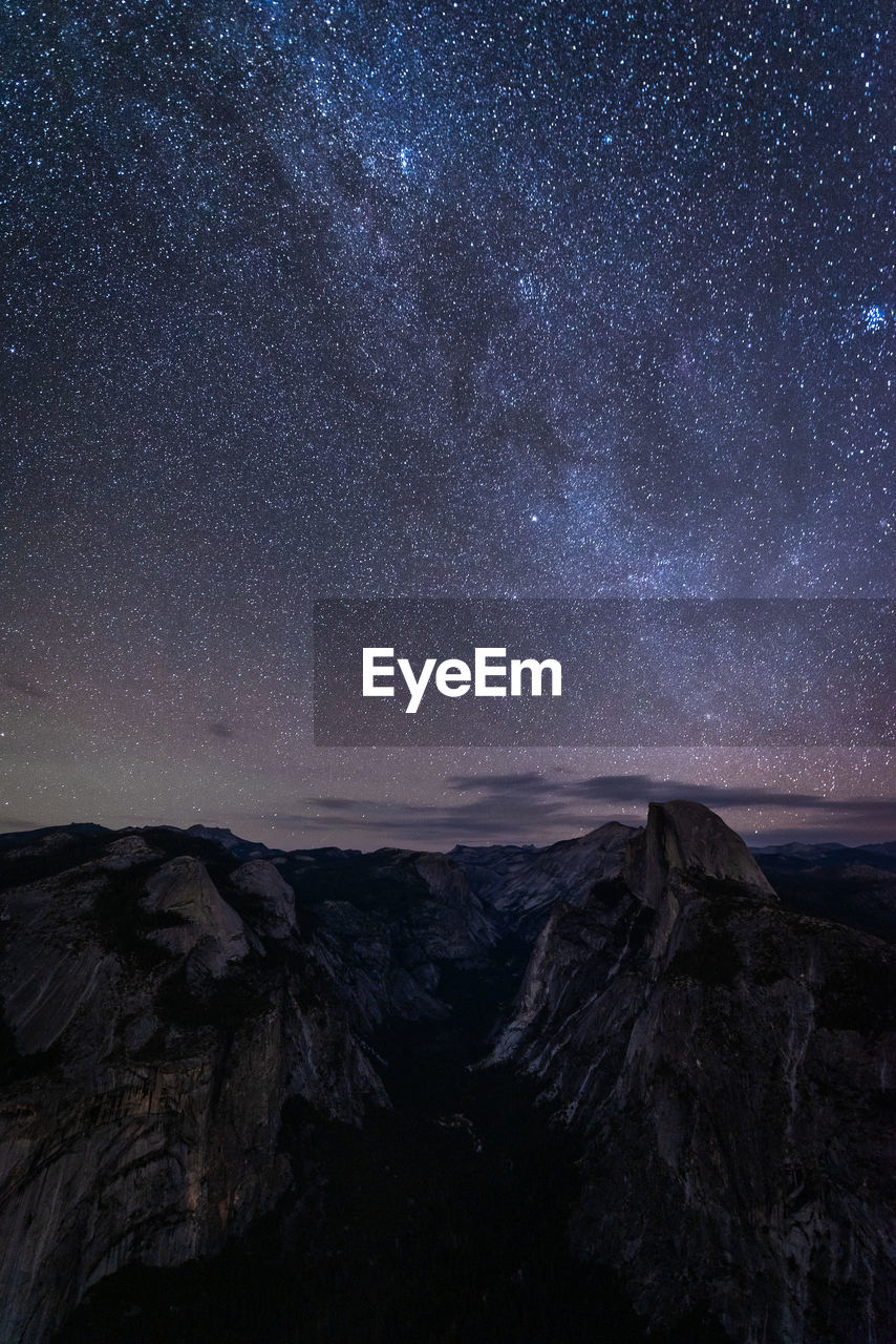 Scenic view of mountains against sky at night