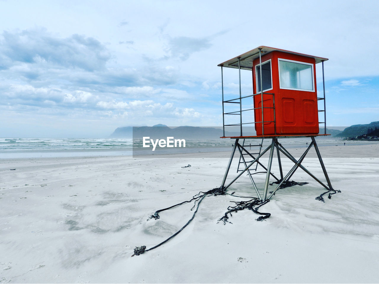 Lifeguard hut on beach against sky