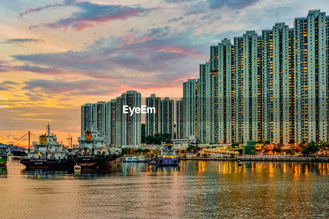 MODERN BUILDINGS AGAINST SKY AT SUNSET