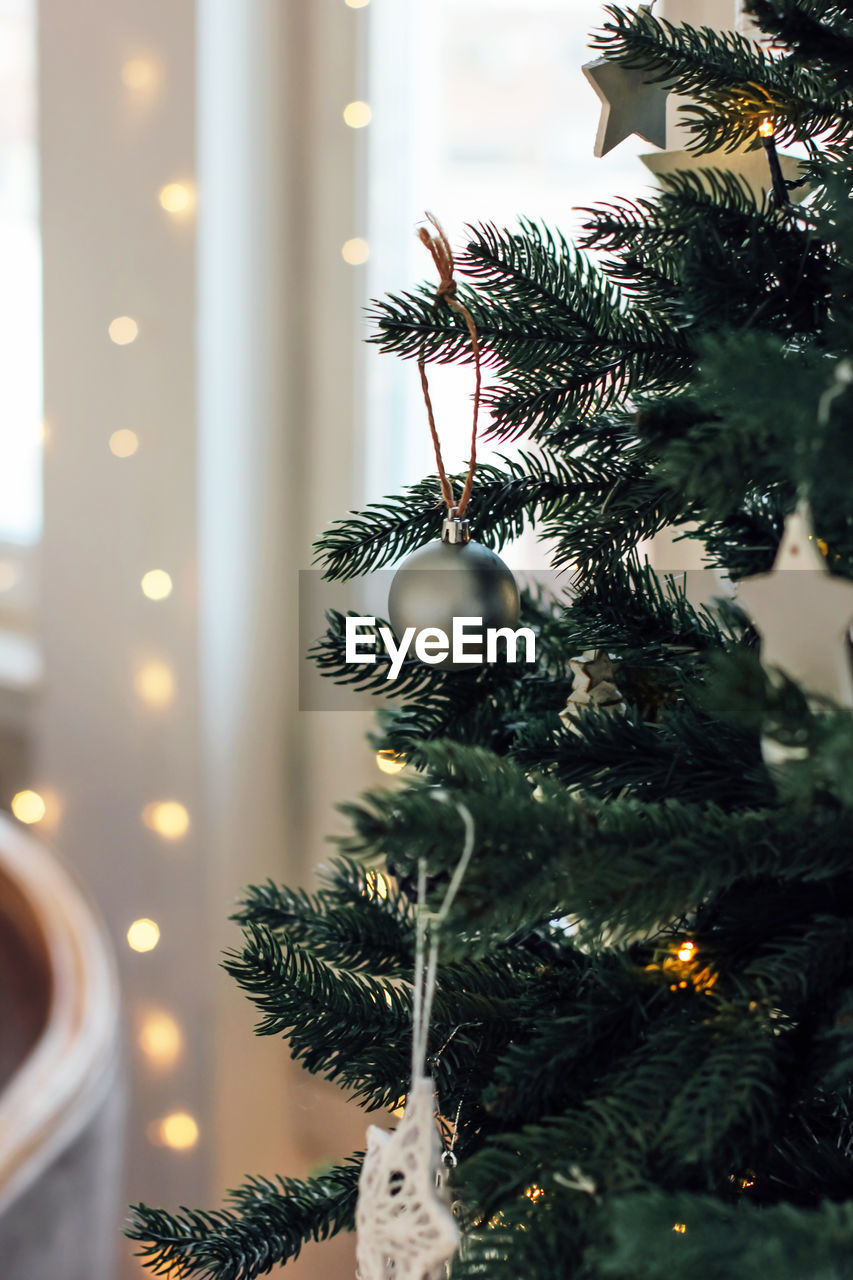 Close-up of bauble hanging on christmas tree at home