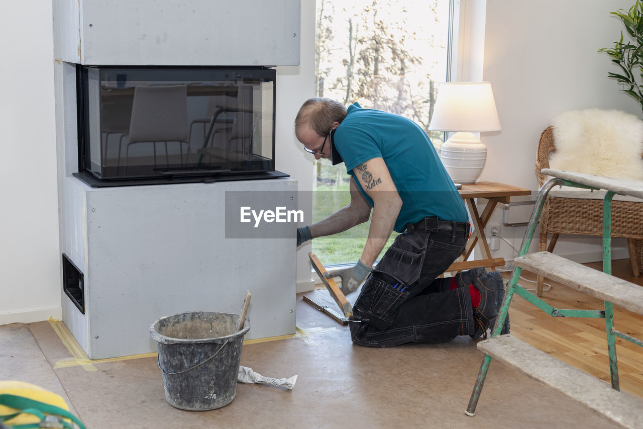 Man installing fireplace