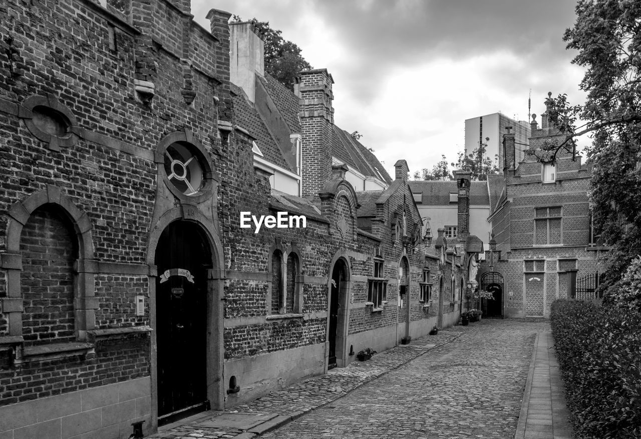 Old buildings against cloudy sky