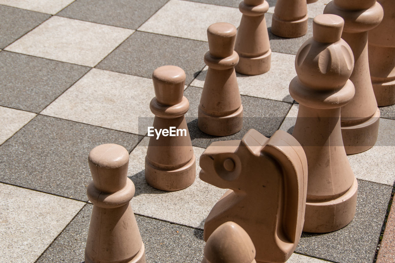 High angle view of chess pieces on floor