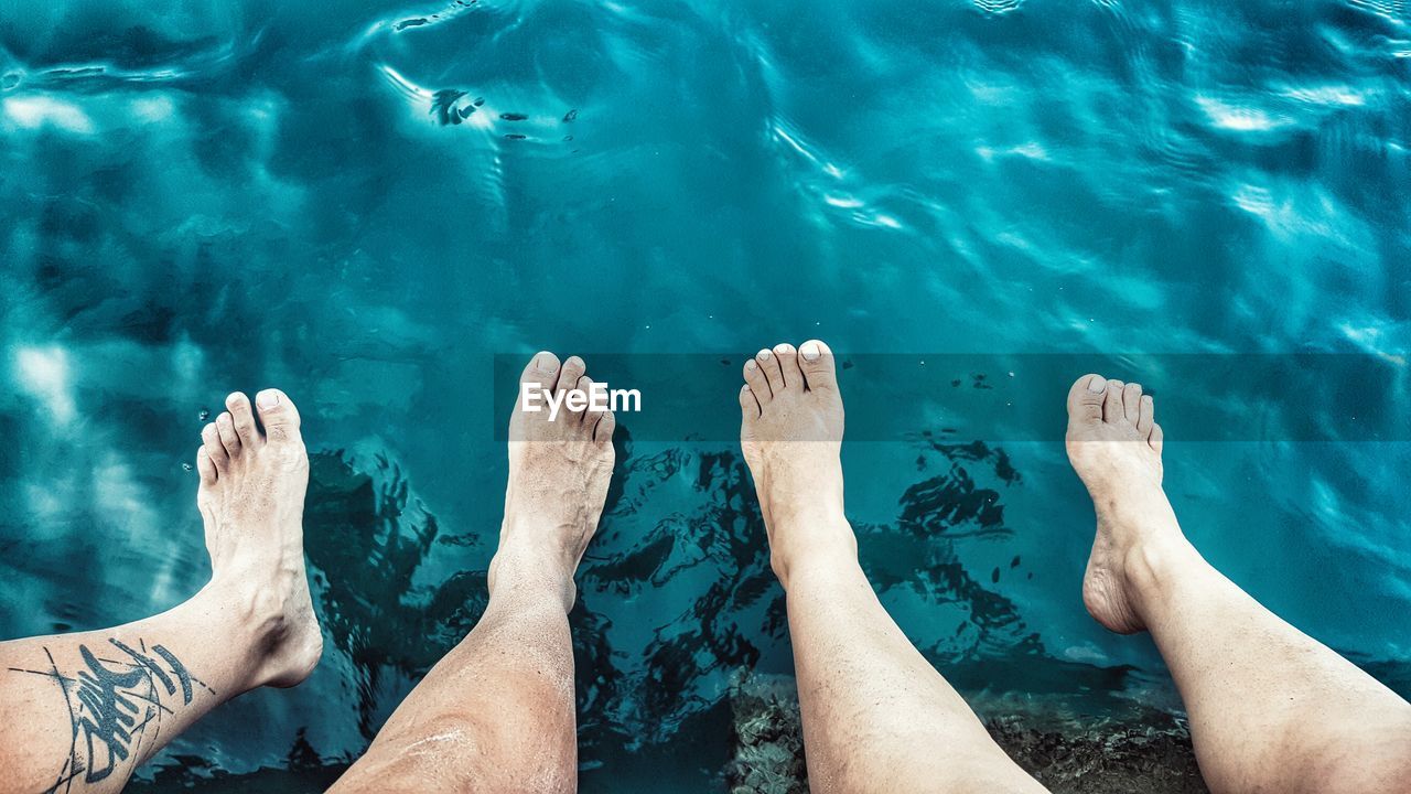 Low section of people relaxing in water