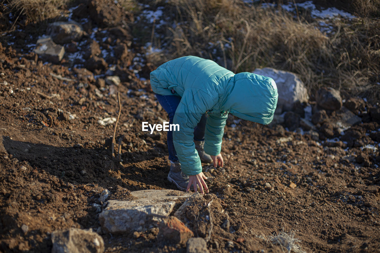 Rear view of boy on field