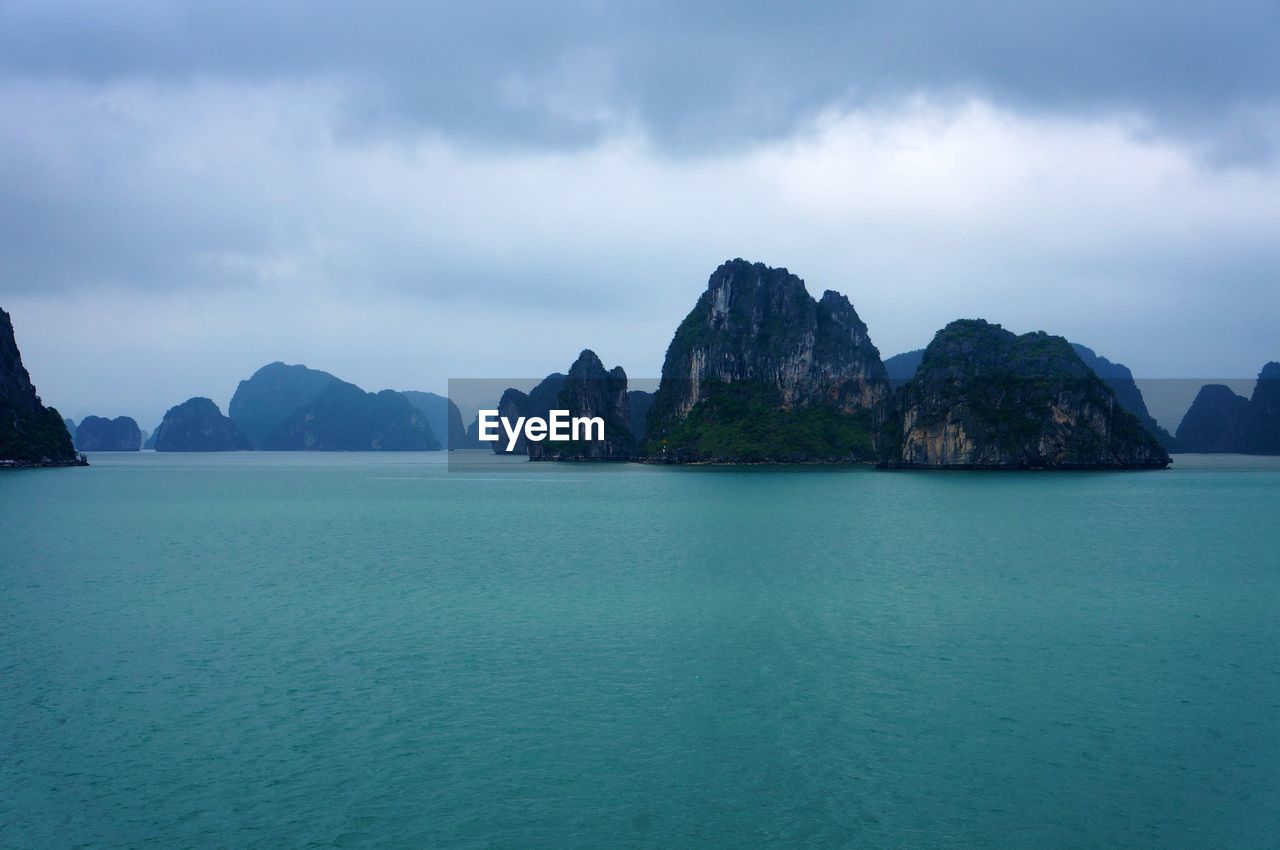 Panoramic view of sea and mountains against sky