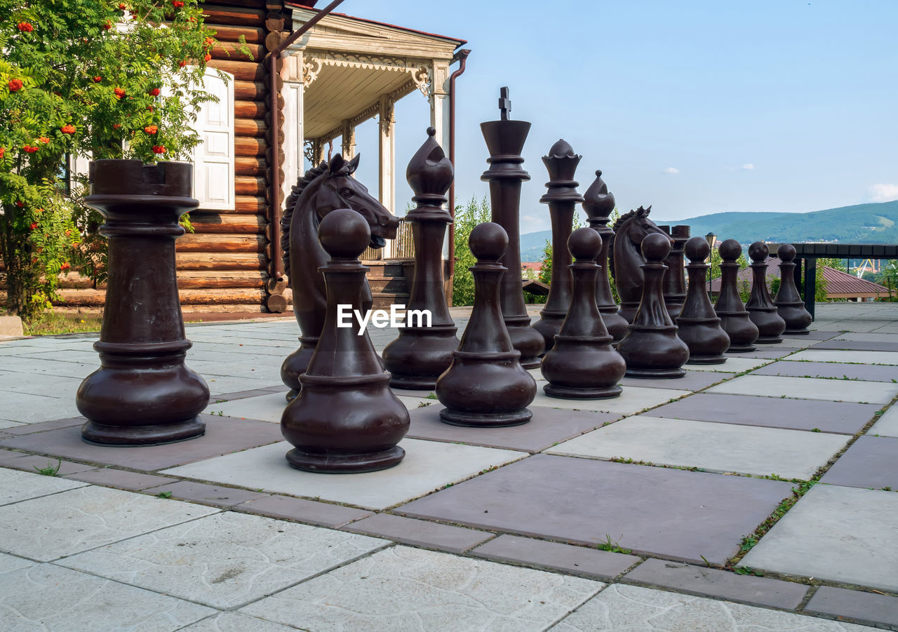game, sports, recreation, chess, board game, indoor games and sports, architecture, leisure games, tabletop game, chess piece, no people, chessboard, nature, day, built structure, relaxation, outdoors, strategy, building exterior, sky, leisure activity, building