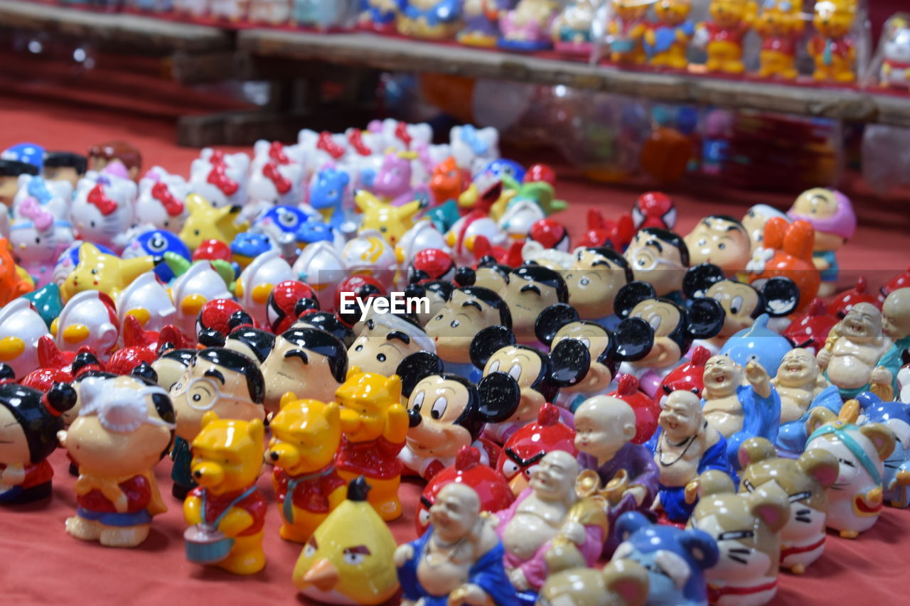 CLOSE-UP OF TOYS FOR SALE AT MARKET STALL