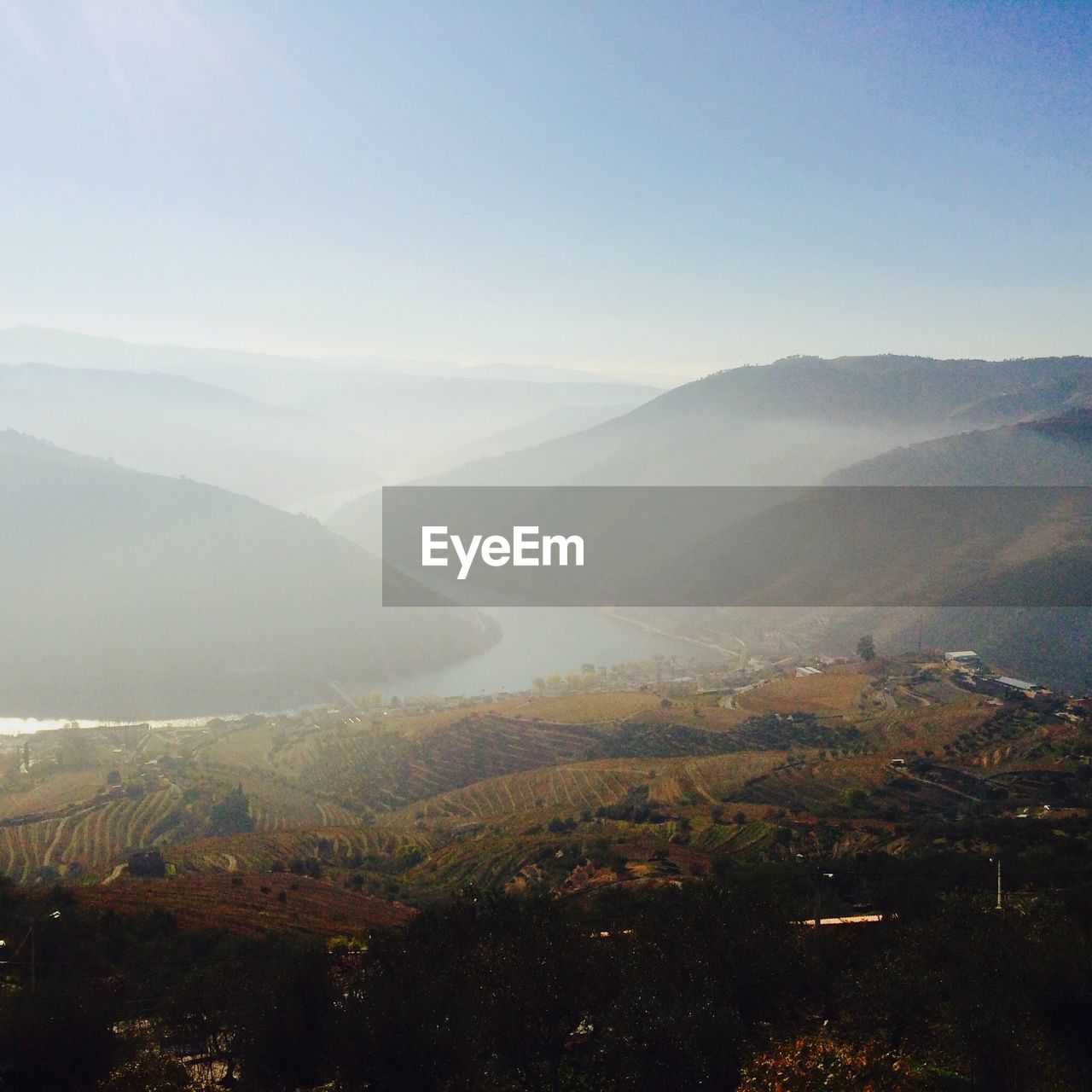 High angle view of mountains against clear sky during foggy weather