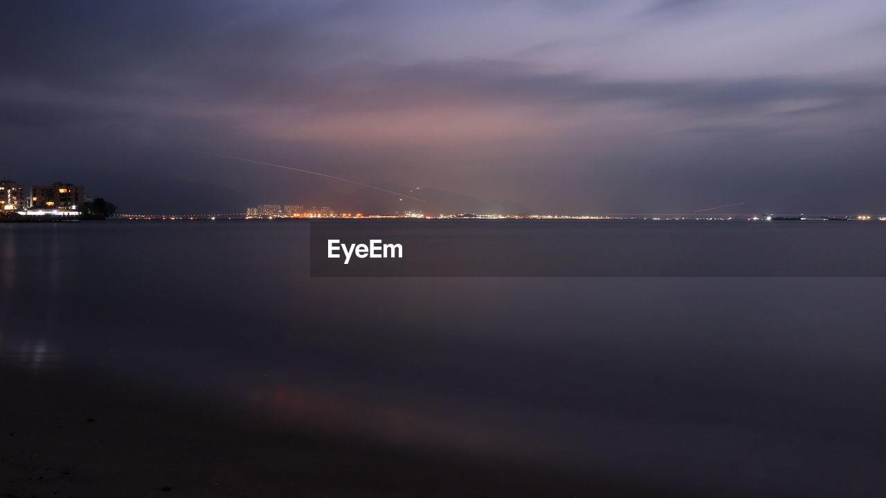Scenic view of sea against sky at night