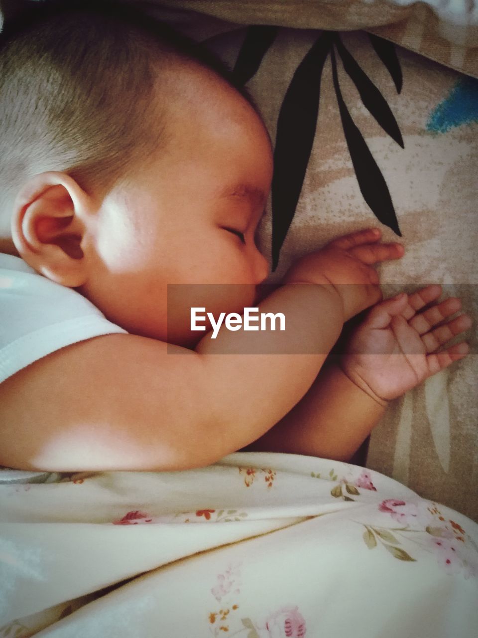 High angle view of baby boy sleeping on bed