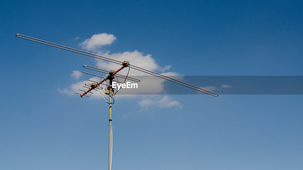 Low angle view of crane against blue sky