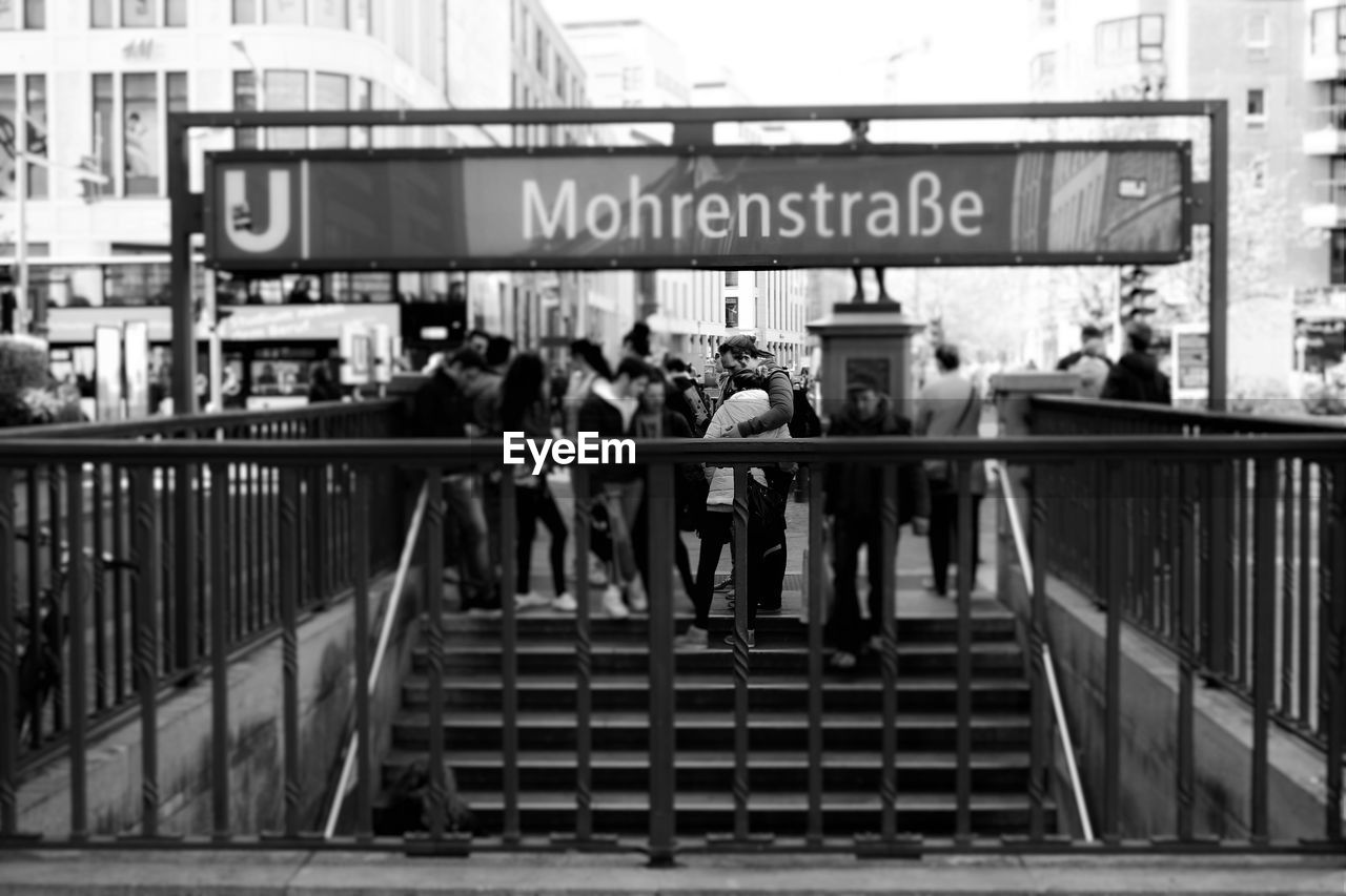 PEOPLE WALKING ON FOOTBRIDGE