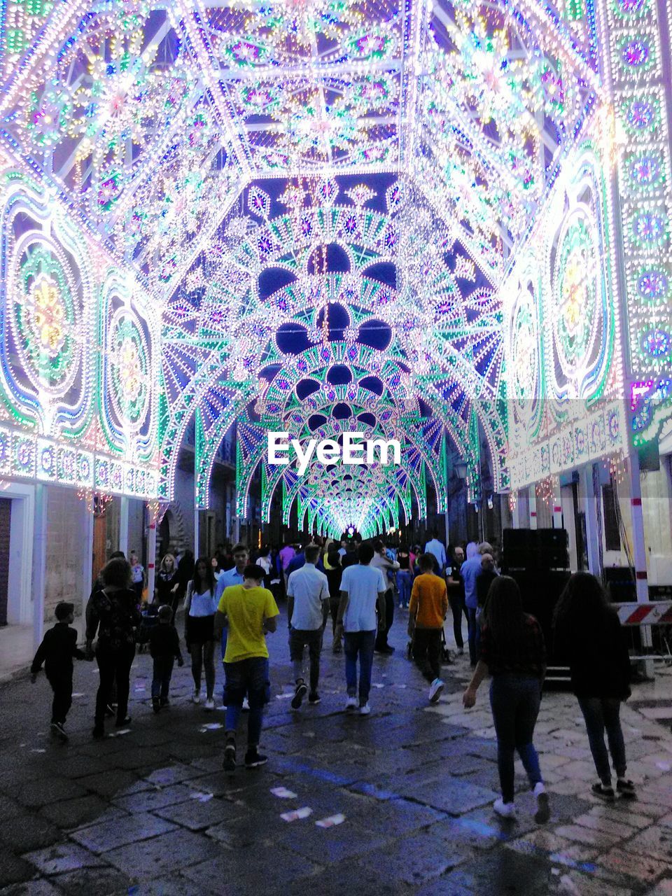 Decorative lights over street at night during festival