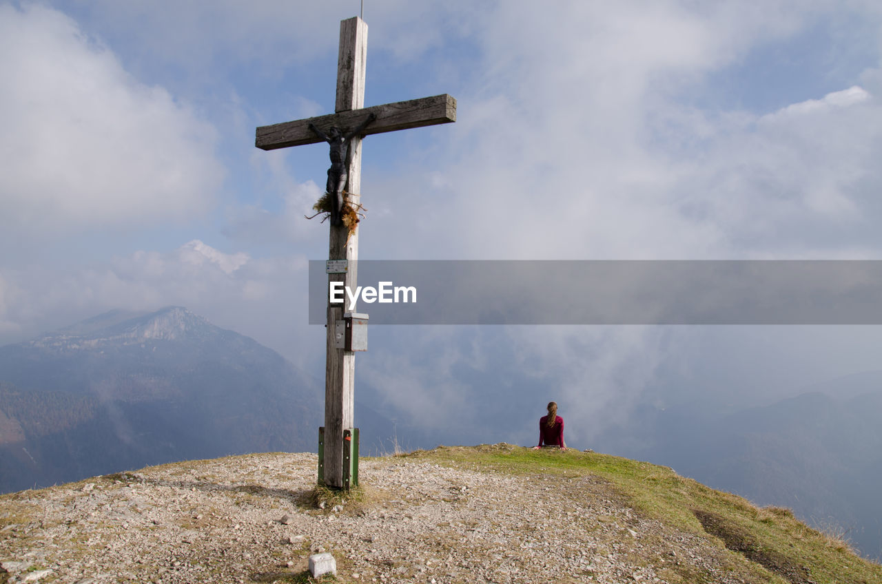 Close-up of cross on mountain against sky 