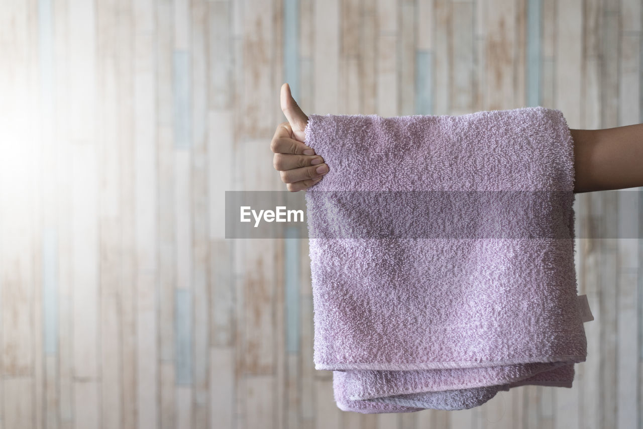 Man showing thumb up with towel hanging on his hand