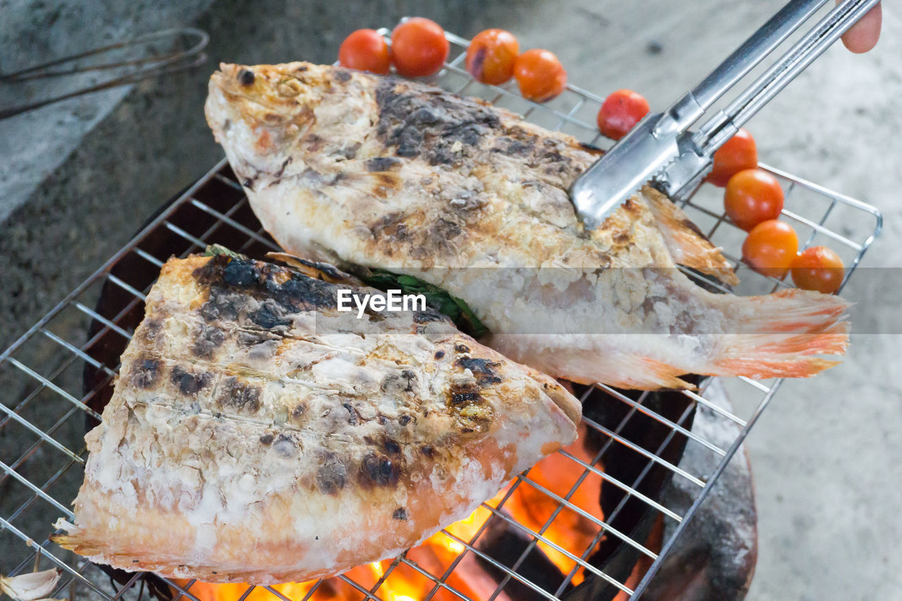 High angle view of meat on barbecue grill