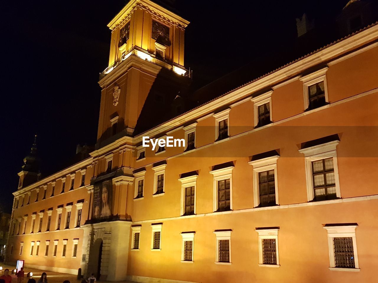 LOW ANGLE VIEW OF ILLUMINATED BUILDING AGAINST CLEAR SKY AT NIGHT