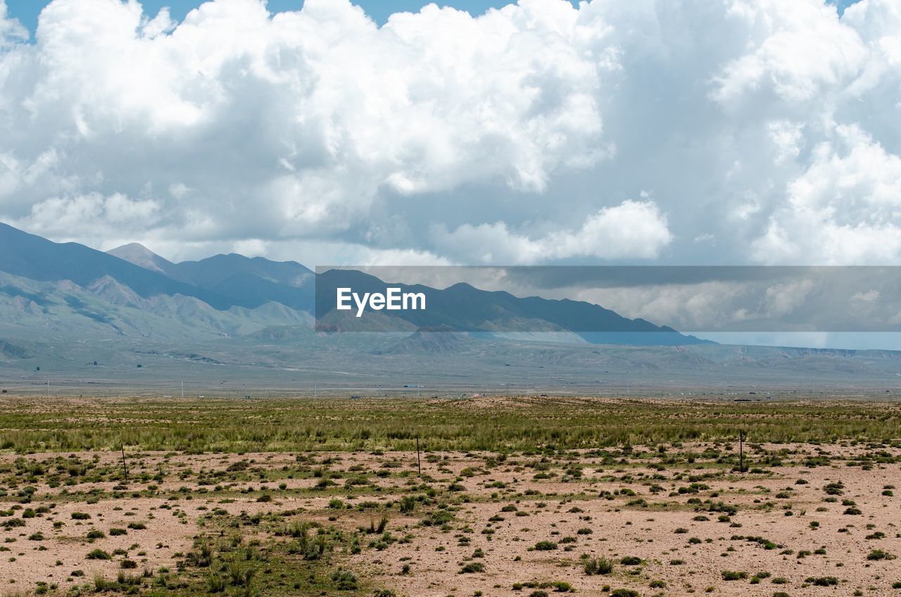 SCENIC VIEW OF LANDSCAPE AND MOUNTAINS AGAINST SKY