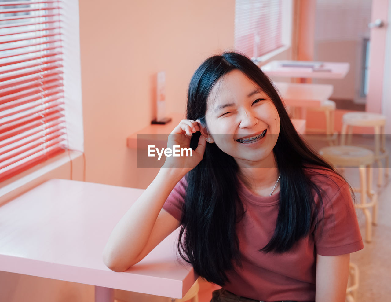 Portrait of smiling teenage girl at table