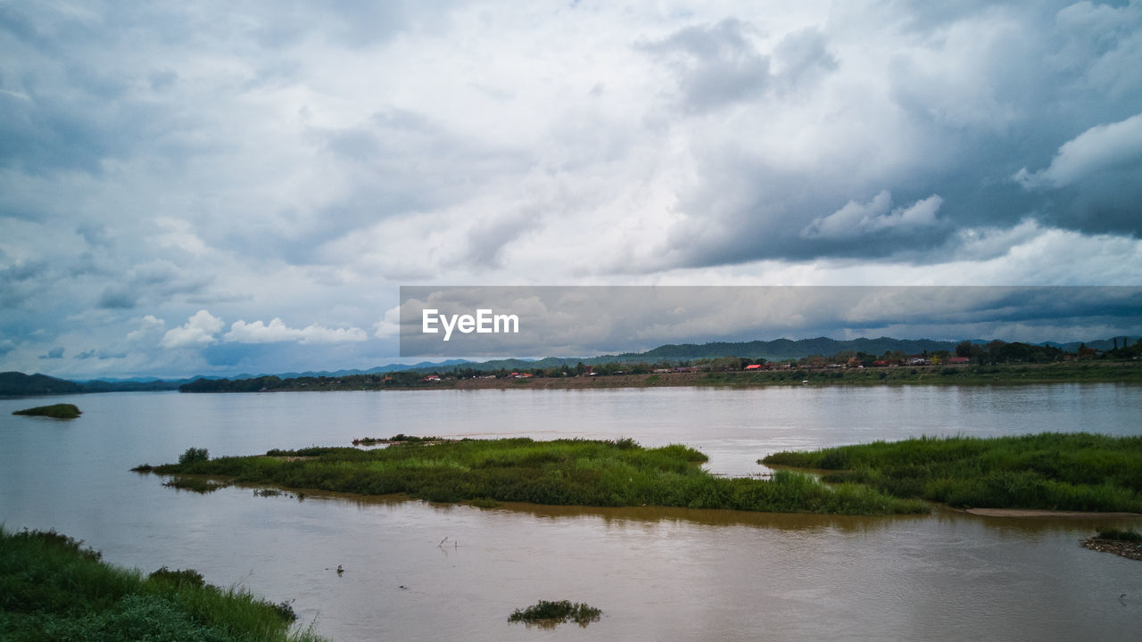 VIEW OF LAKE AGAINST CLOUDY SKY