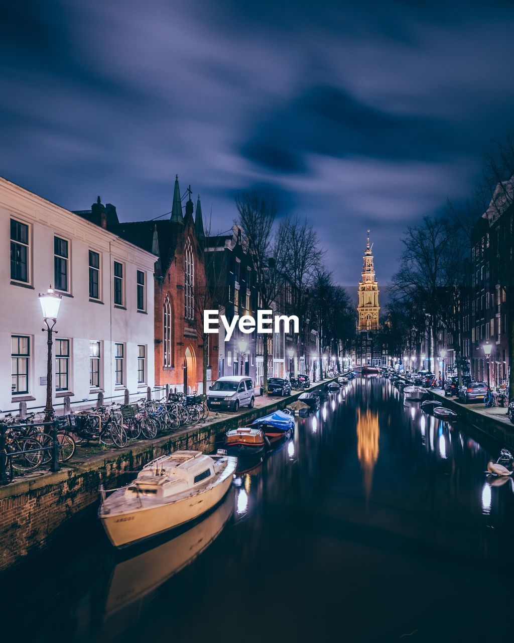 Boats moored on canal in city