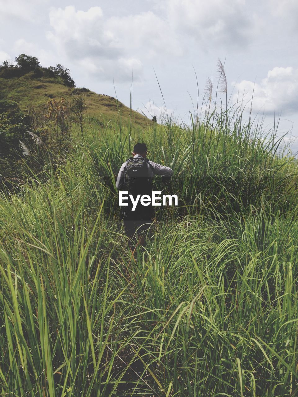 MAN STANDING ON GRASS